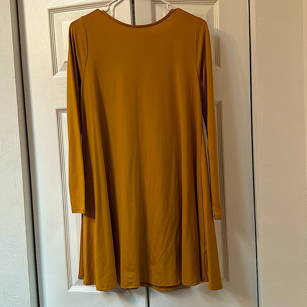 Francesca’s mustard yellow long sleeve dress with low-cut back.